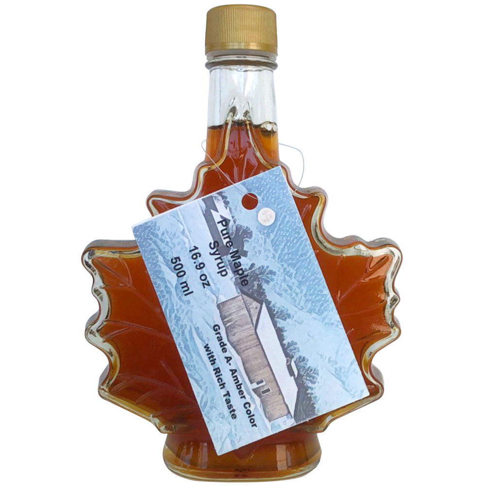 A 500ml (16.9oz) Maple Leaf Shaped Glass Bottle of Amber Maple Syrup